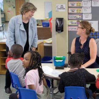 randi speaking to a teacher in a classroom
